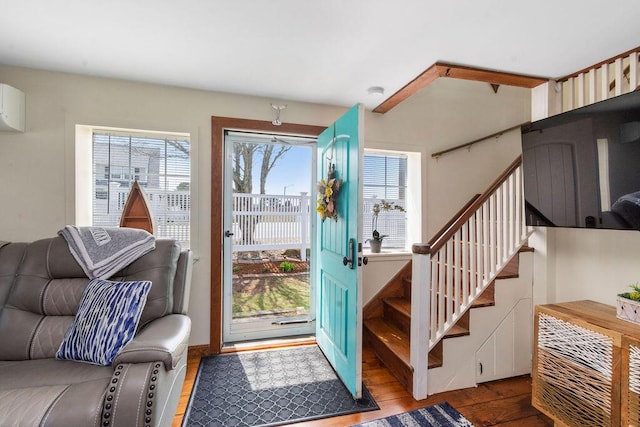 foyer with wood finished floors and stairway
