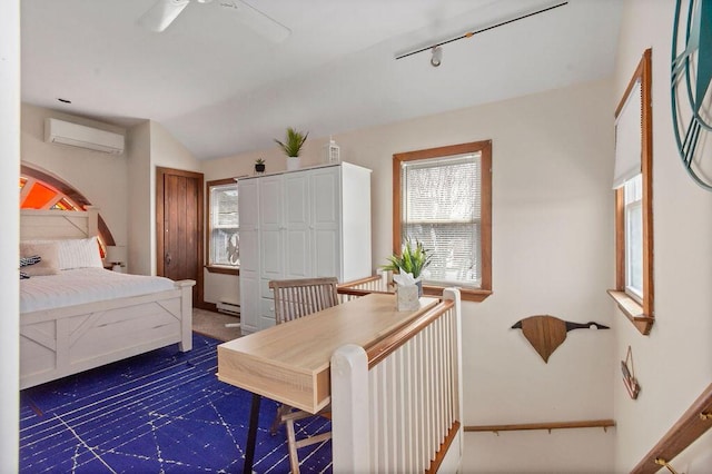 bedroom featuring baseboards, multiple windows, and a wall mounted air conditioner