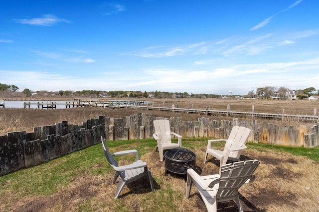view of yard with fence and an outdoor fire pit