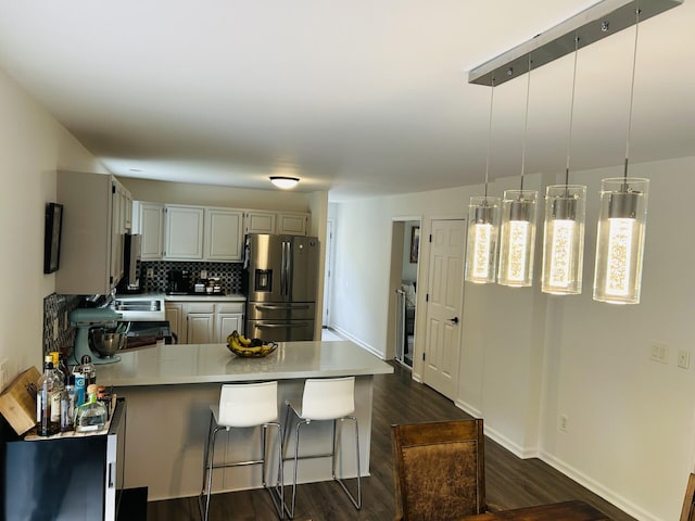 50 Great Hill Rd, Sandwich, MA 02563 - kitchen featuring stainless steel fridge with ice dispenser, a peninsula, light countertops, dark wood-type flooring, and backsplash