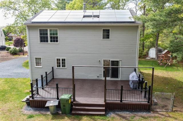 50 Great Hill Rd, Sandwich, MA 02563 - back of house featuring solar panels, a gate, a deck, and a yard