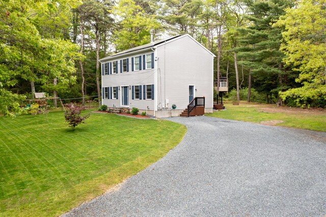 50 Great Hill Rd, Sandwich, MA 02563 - colonial inspired home featuring gravel driveway, a front yard, and view of wooded area
