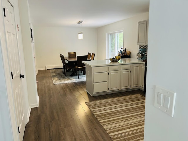 50 Great Hill Rd, Sandwich, MA 02563 - kitchen with a peninsula, dark wood-style floors, light countertops, pendant lighting, and baseboards