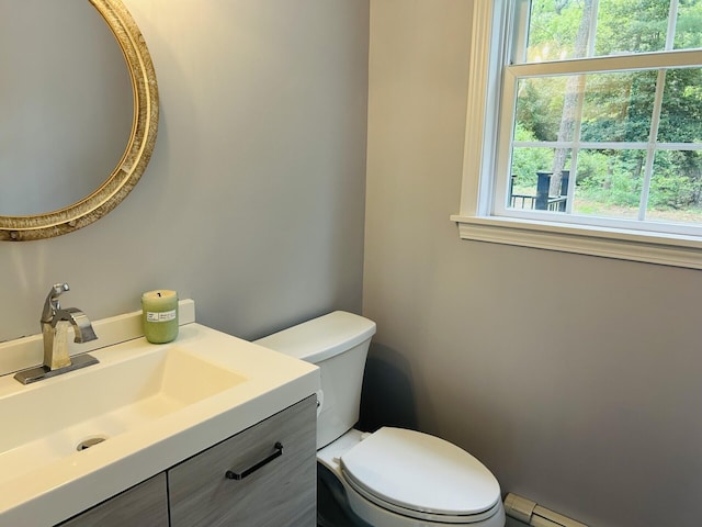 50 Great Hill Rd, Sandwich, MA 02563 - bathroom with healthy amount of natural light, a baseboard radiator, vanity, and toilet