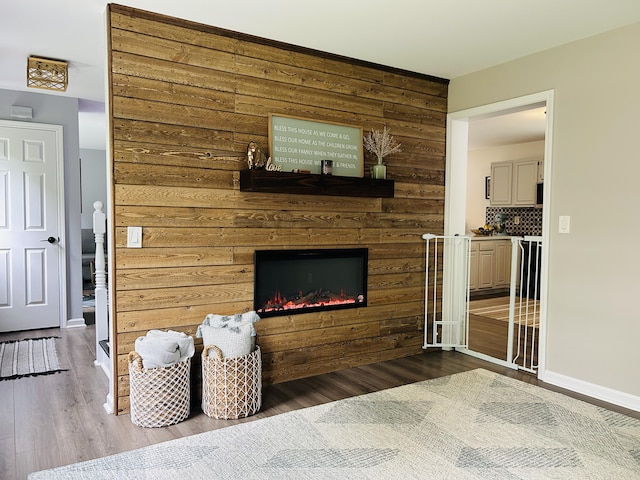 50 Great Hill Rd, Sandwich, MA 02563 - living area with wood finished floors, a large fireplace, wooden walls, and baseboards