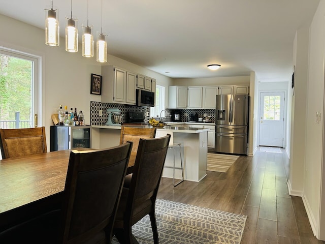 50 Great Hill Rd, Sandwich, MA 02563 - kitchen with stainless steel appliances, decorative backsplash, a peninsula, and pendant lighting
