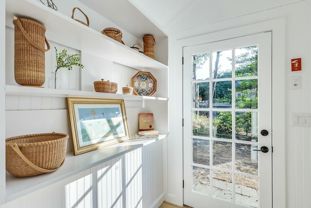 doorway to outside with vaulted ceiling