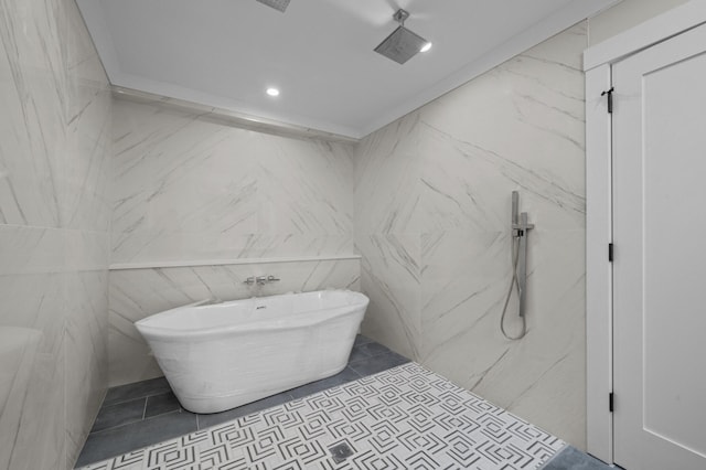 bathroom with a bathing tub and tile patterned floors