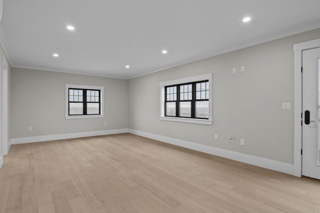 empty room featuring light hardwood / wood-style floors and crown molding