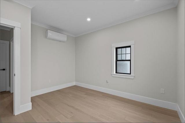 spare room with crown molding, light hardwood / wood-style floors, and a wall mounted AC