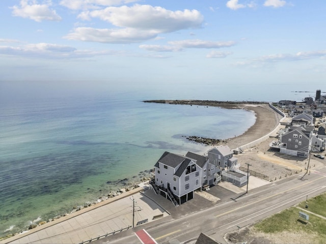 drone / aerial view featuring a water view and a beach view