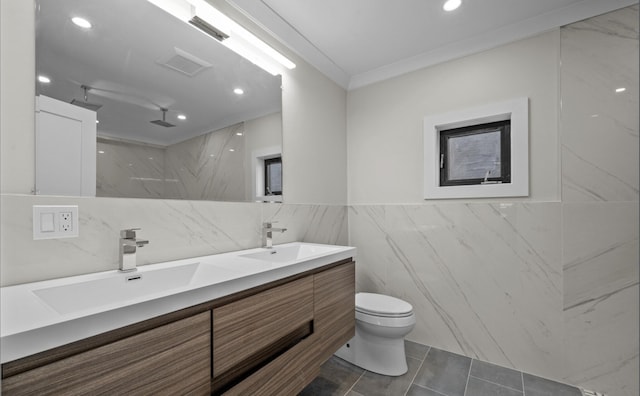 bathroom featuring toilet, walk in shower, tile walls, ornamental molding, and vanity