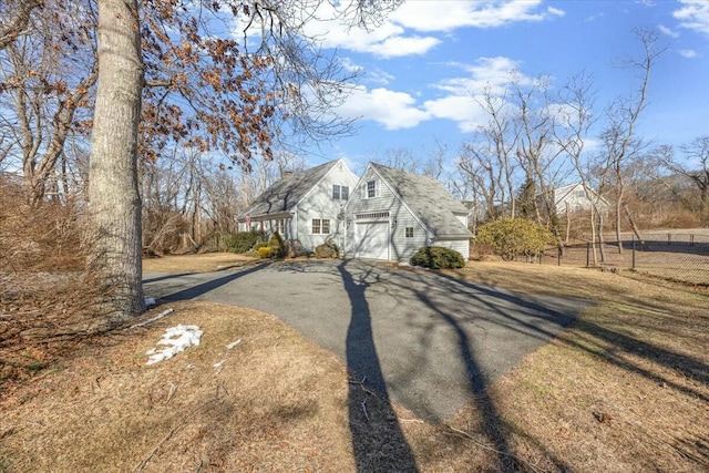 view of front of property featuring aphalt driveway and an attached garage