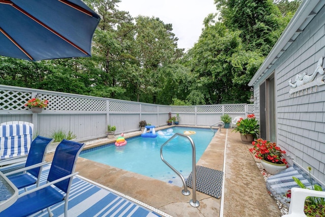 view of swimming pool with a fenced in pool, a fenced backyard, and a patio