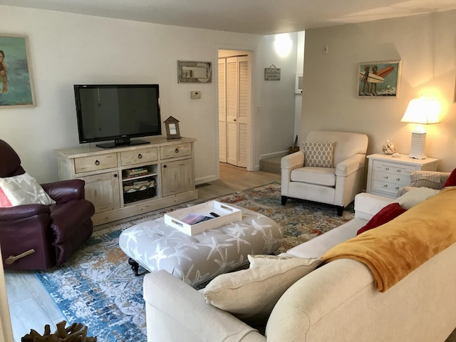 living area with wood finished floors and baseboards