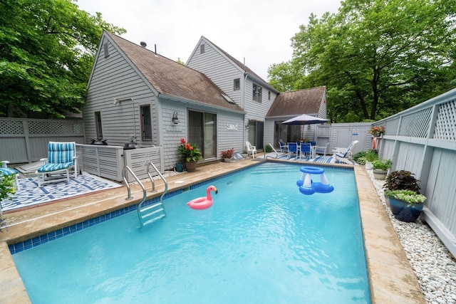 view of pool featuring a patio area, a fenced backyard, and a fenced in pool