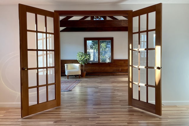 doorway to outside with french doors, beamed ceiling, and hardwood / wood-style floors