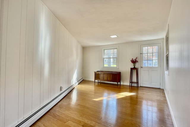 foyer featuring wood-type flooring and baseboard heating