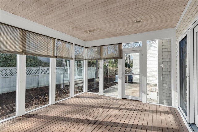 unfurnished sunroom featuring wood ceiling