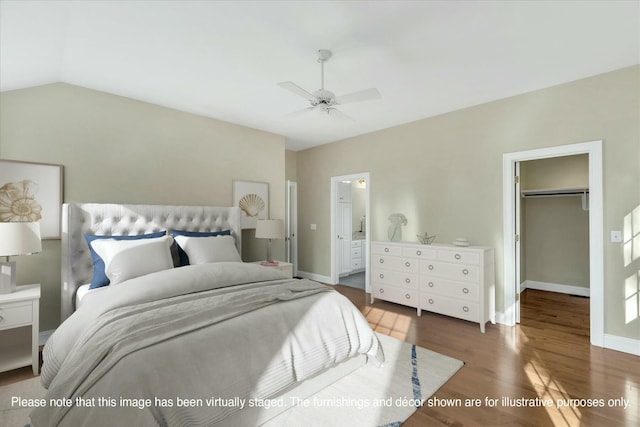 bedroom with a walk in closet, connected bathroom, dark hardwood / wood-style floors, a closet, and ceiling fan