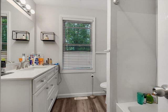 452 Nathan Ellis Hwy, Mashpee, MA 02649 - full bathroom with wood finished floors, vanity, a bathtub, and wainscoting