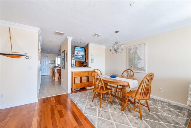 29 Highland Ter Unit 2903, Plymouth, MA 02360 - dining room featuring a chandelier, crown molding, light wood-style flooring, and baseboards