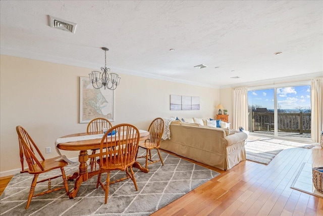 29 Highland Ter Unit 2903, Plymouth, MA 02360 - dining room featuring a chandelier, wood finished floors, crown molding, and a textured ceiling