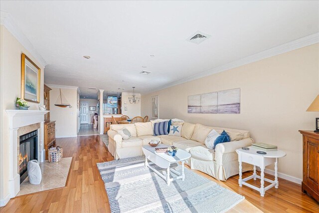29 Highland Ter Unit 2903, Plymouth, MA 02360 - living area with light wood finished floors, ornamental molding, a fireplace, and baseboards