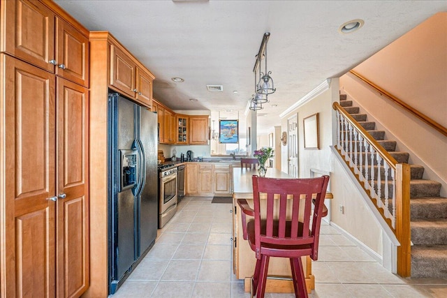 29 Highland Ter Unit 2903, Plymouth, MA 02360 - kitchen featuring black fridge, gas stove, light tile patterned flooring, recessed lighting, and a center island