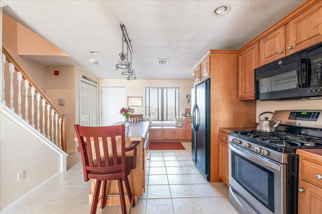 29 Highland Ter Unit 2903, Plymouth, MA 02360 - kitchen with black appliances, light tile patterned floors, brown cabinetry, and baseboards