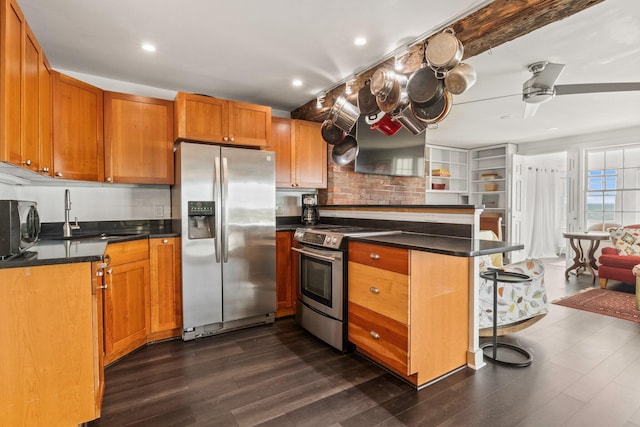 633 Commercial St Unit 2, Provincetown, MA 02657 - kitchen with dark countertops, a peninsula, appliances with stainless steel finishes, and a sink
