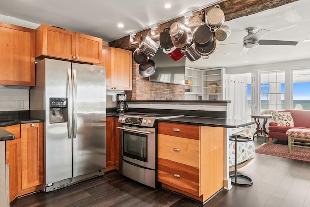 633 Commercial St Unit 2, Provincetown, MA 02657 - kitchen featuring a breakfast bar area, stainless steel appliances, a peninsula, a ceiling fan, and dark countertops