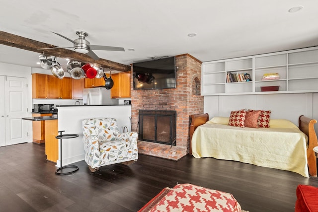 633 Commercial St Unit 2, Provincetown, MA 02657 - living room with dark wood-type flooring, beam ceiling, a fireplace, and ceiling fan