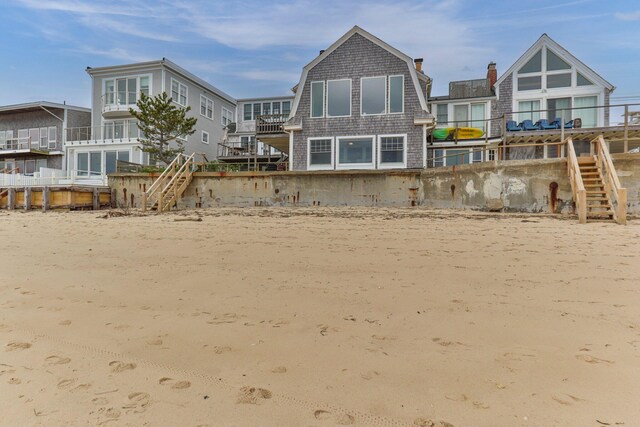 633 Commercial St Unit 2, Provincetown, MA 02657 - rear view of house featuring stairway and a gambrel roof