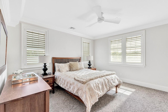 carpeted bedroom with a ceiling fan, baseboards, visible vents, and crown molding