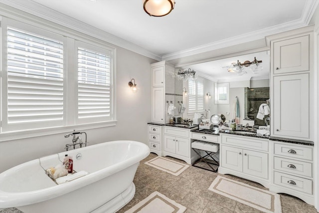 bathroom featuring a sink, two vanities, a freestanding bath, ornamental molding, and a shower stall