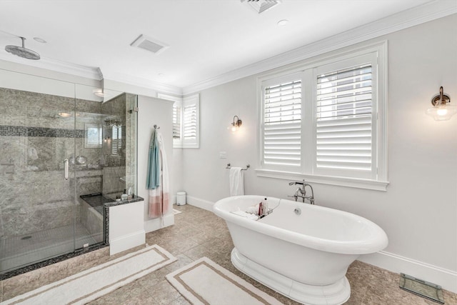 full bathroom with ornamental molding, a freestanding tub, visible vents, and baseboards