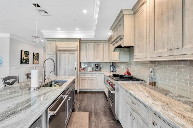 kitchen with visible vents, dark wood finished floors, light stone counters, stainless steel appliances, and a sink