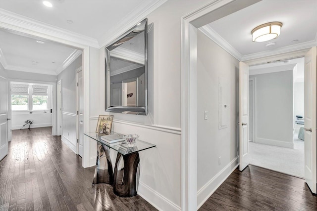 hall featuring baseboards, ornamental molding, and wood finished floors