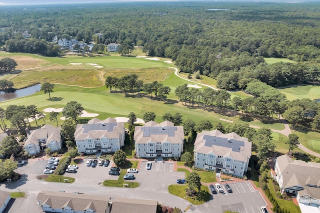 birds eye view of property featuring a residential view, view of golf course, a water view, and a wooded view