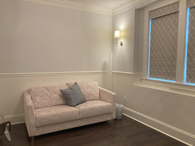 sitting room with baseboards, wood finished floors, and crown molding