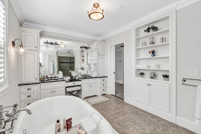 bathroom with built in shelves, a freestanding tub, vanity, a stall shower, and crown molding