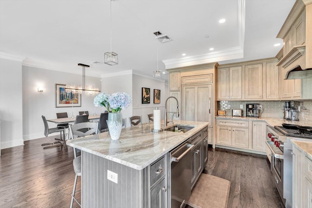 kitchen with decorative backsplash, dark wood-style floors, a kitchen breakfast bar, stainless steel appliances, and a sink