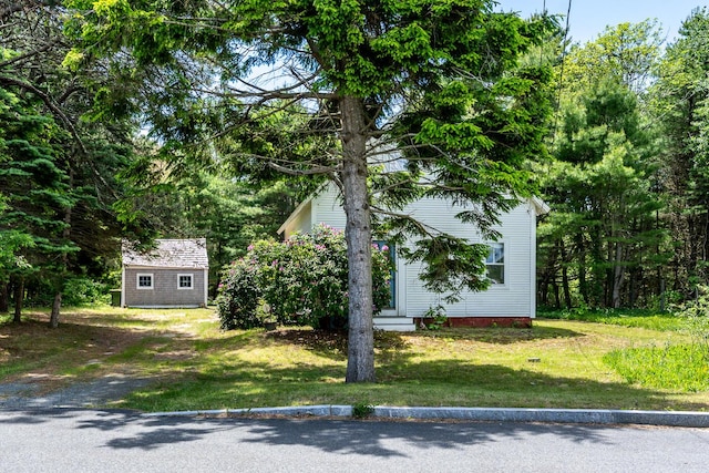 301 Main St, Dennis Port, MA 02639 - view of home's exterior featuring an outbuilding and a lawn