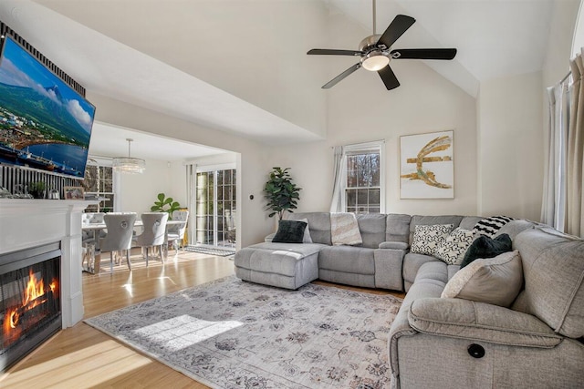 living room featuring wood-type flooring, vaulted ceiling, and ceiling fan