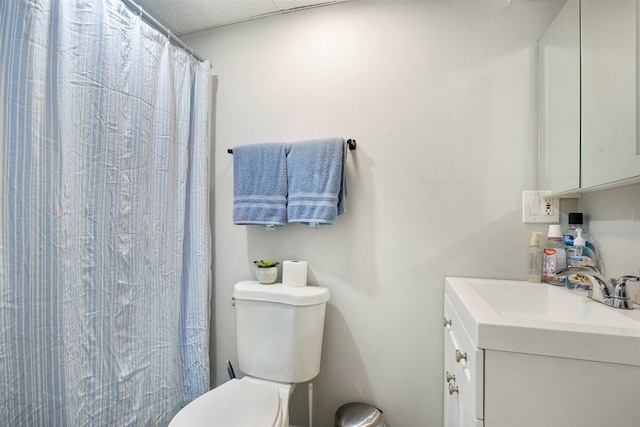 bathroom featuring vanity, a shower with shower curtain, and toilet