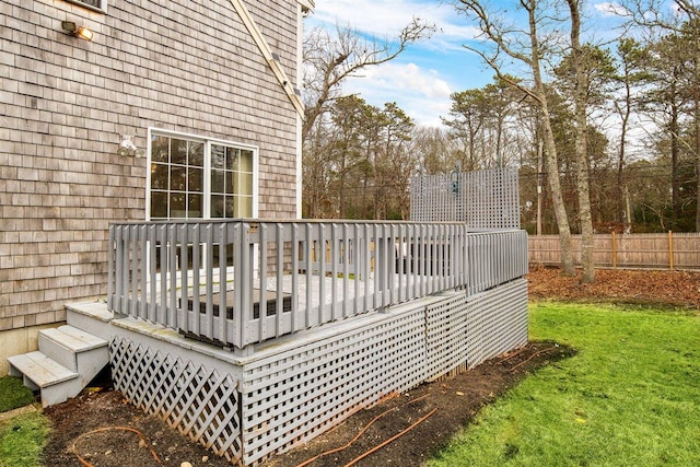 wooden deck featuring a lawn