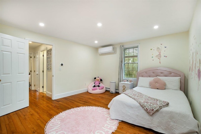 bedroom featuring hardwood / wood-style flooring, an AC wall unit, and baseboard heating