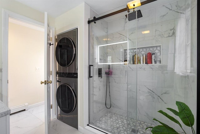 bathroom featuring stacked washer / drying machine, a shower with door, and a baseboard heating unit