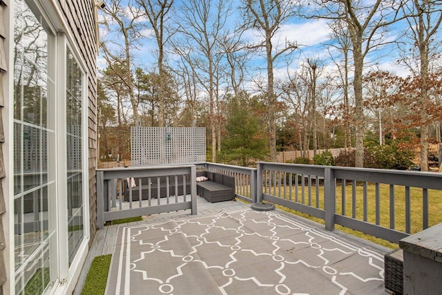 wooden terrace with a lawn